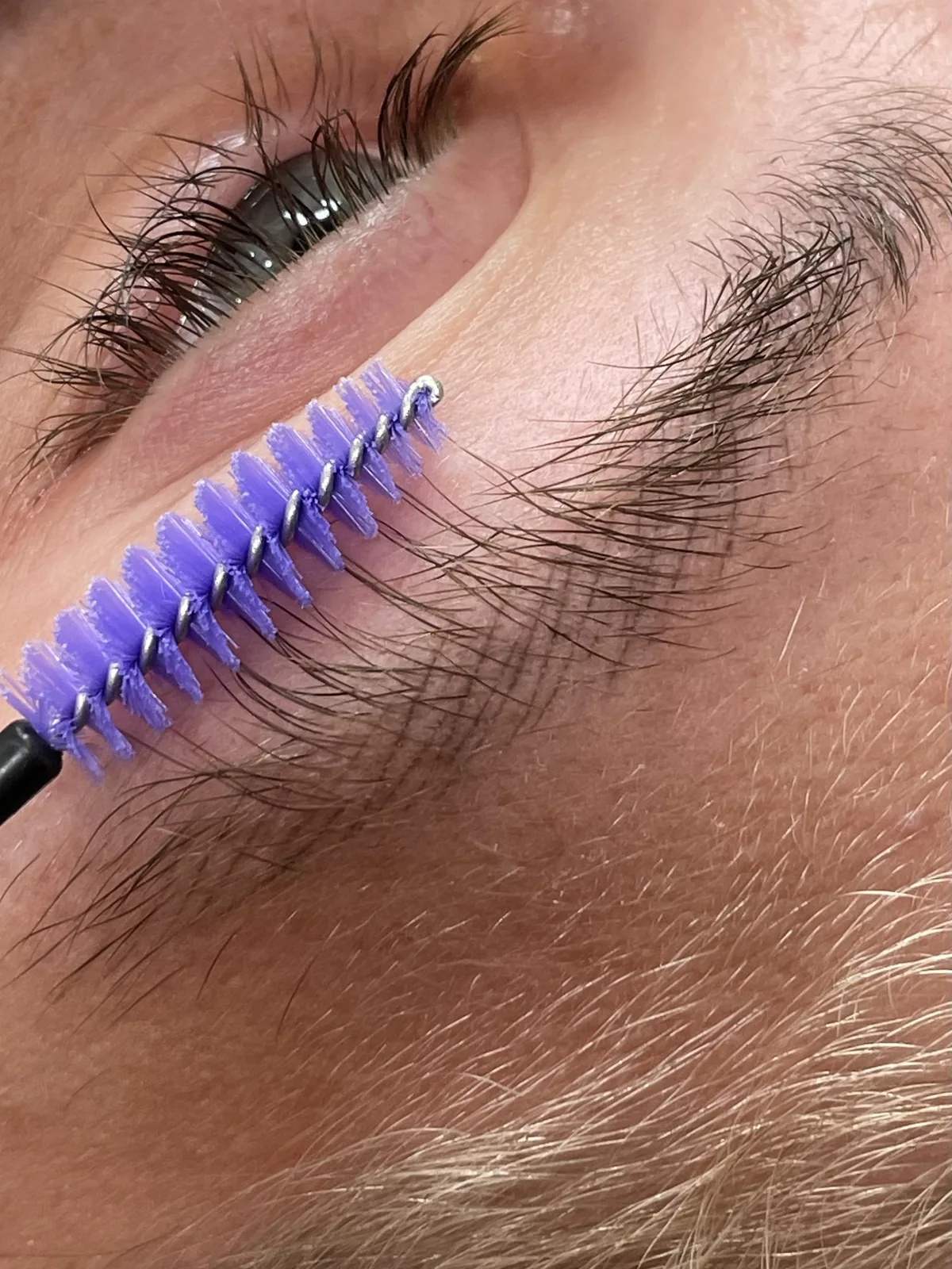 Natural hair brushed upward with a spoolie, healed strokes visible underneath